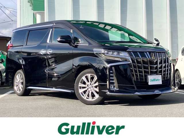 トヨタ アルファード S タイプゴールド 静岡県 2020(令2)年 5.1万km ブラック エンジンスタートボタン/パワーステアリング/パワーウィンドウ/100V充電/スマートキー/スペアキー/Wオートエアコン/クルーズコントロール/純正フリップダウンモニター/USB入力端子/ETC2.0/バックカメラ/純正ナビ（CD/DVD/BT/フルセグ）/三列シート/オットマン/電動リアゲート/ドライブレコーダー前後/ウォークスルー/純正フロアマット/ハーフレザー/両側パワースライドドア/モデリスタエアロ（フロント）/純正アルミホイール/ABS/横滑り防止装置/コーナーセンサー前後/レーンキープアシスト/盗難防止装置/オートライト/オートマチックハイビーム/三眼LEDヘッドライト/W＋サイドエアバック/衝突軽減システム/カーテンエアバック