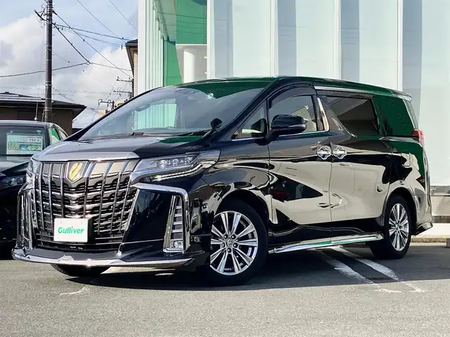 トヨタ アルファード S タイプゴールド 静岡県 2020(令2)年 5.1万km ブラック エンジンスタートボタン/パワーステアリング/パワーウィンドウ/100V充電/スマートキー/スペアキー/Wオートエアコン/クルーズコントロール/純正フリップダウンモニター/USB入力端子/ETC2.0/バックカメラ/純正ナビ（CD/DVD/BT/フルセグ）/三列シート/オットマン/電動リアゲート/ドライブレコーダー前後/ウォークスルー/純正フロアマット/ハーフレザー/両側パワースライドドア/モデリスタエアロ（フロント）/純正アルミホイール/ABS/横滑り防止装置/コーナーセンサー前後/レーンキープアシスト/盗難防止装置/オートライト/オートマチックハイビーム/三眼LEDヘッドライト/W＋サイドエアバック/衝突軽減システム/カーテンエアバック