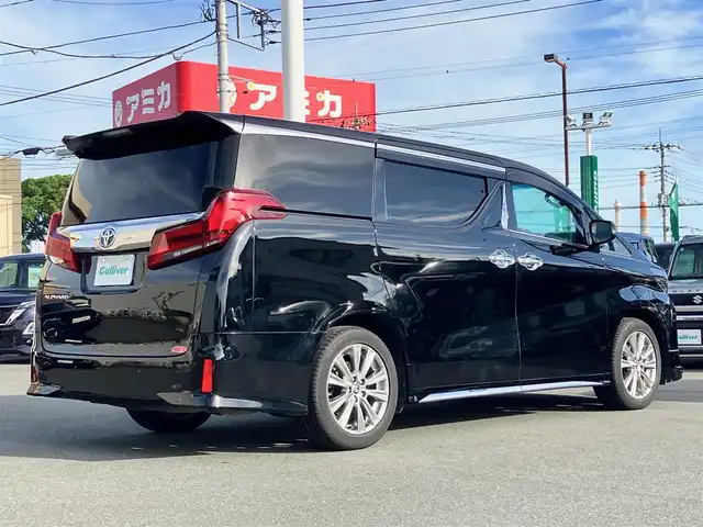 トヨタ アルファード S タイプゴールド 静岡県 2020(令2)年 5.1万km ブラック エンジンスタートボタン/パワーステアリング/パワーウィンドウ/100V充電/スマートキー/スペアキー/Wオートエアコン/クルーズコントロール/純正フリップダウンモニター/USB入力端子/ETC2.0/バックカメラ/純正ナビ（CD/DVD/BT/フルセグ）/三列シート/オットマン/電動リアゲート/ドライブレコーダー前後/ウォークスルー/純正フロアマット/ハーフレザー/両側パワースライドドア/モデリスタエアロ（フロント）/純正アルミホイール/ABS/横滑り防止装置/コーナーセンサー前後/レーンキープアシスト/盗難防止装置/オートライト/オートマチックハイビーム/三眼LEDヘッドライト/W＋サイドエアバック/衝突軽減システム/カーテンエアバック