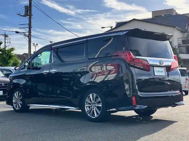 トヨタ アルファード S タイプゴールド 静岡県 2020(令2)年 5.1万km ブラック エンジンスタートボタン/パワーステアリング/パワーウィンドウ/100V充電/スマートキー/スペアキー/Wオートエアコン/クルーズコントロール/純正フリップダウンモニター/USB入力端子/ETC2.0/バックカメラ/純正ナビ（CD/DVD/BT/フルセグ）/三列シート/オットマン/電動リアゲート/ドライブレコーダー前後/ウォークスルー/純正フロアマット/ハーフレザー/両側パワースライドドア/モデリスタエアロ（フロント）/純正アルミホイール/ABS/横滑り防止装置/コーナーセンサー前後/レーンキープアシスト/盗難防止装置/オートライト/オートマチックハイビーム/三眼LEDヘッドライト/W＋サイドエアバック/衝突軽減システム/カーテンエアバック
