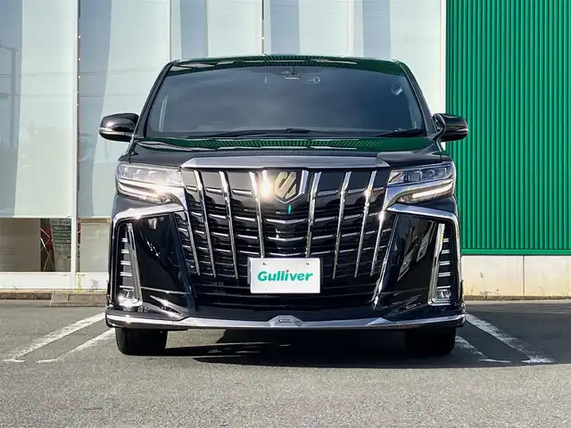 トヨタ アルファード S タイプゴールド 静岡県 2020(令2)年 5.1万km ブラック エンジンスタートボタン/パワーステアリング/パワーウィンドウ/100V充電/スマートキー/スペアキー/Wオートエアコン/クルーズコントロール/純正フリップダウンモニター/USB入力端子/ETC2.0/バックカメラ/純正ナビ（CD/DVD/BT/フルセグ）/三列シート/オットマン/電動リアゲート/ドライブレコーダー前後/ウォークスルー/純正フロアマット/ハーフレザー/両側パワースライドドア/モデリスタエアロ（フロント）/純正アルミホイール/ABS/横滑り防止装置/コーナーセンサー前後/レーンキープアシスト/盗難防止装置/オートライト/オートマチックハイビーム/三眼LEDヘッドライト/W＋サイドエアバック/衝突軽減システム/カーテンエアバック