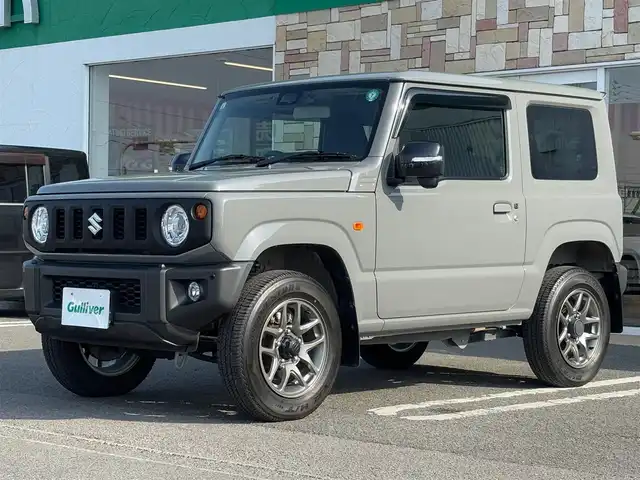 スズキ ジムニー XC 徳島県 2021(令3)年 1.9万km ミディアムグレー 社外ナビ(CN-RZ865)/(CD・DVD/Bluetooth/TV)/バックカメラ/ステアリングスイッチ/純正ビルトインETC/社外前方ドライブレコーダー/衝突被害軽減ブレーキ/クルーズコントロール/レーンキープアシスト/前後コーナーセンサー/ダウンヒルアシストコントロール/オートライト/LEDヘッドライト/フロントフォグライト/純正16インチアルミホイール/背面タイヤ/背面ハードカバー/純正ドアバイザー/ヘッドライトウォッシャー