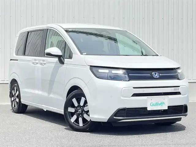 ホンダ フリード ハイブリット e:HEV AIR EX 群馬県 2025(令7)年 0.1千km プラチナホワイトパール ホンダセンシング/・衝突軽減ブレーキ（CMBS）/・車線維持支援システム（LKAS）/・アダプティブクルーズコントロール（ACC）/・後方誤発進抑制機能/・誤発進抑制機能/・車線逸脱支援/・先行車発進お知らせ/純正ディスプレイオーディオ/【Apple CarＰlay　Android Auto対応/ＢＴ】/バックカメラ/ハーフレザーシート/シートヒーター（Ｄ席/Ｎ席）/両側パワースライドドア/LEDヘッドライト/純正ＡＷ/保証書/取説/スペアキー