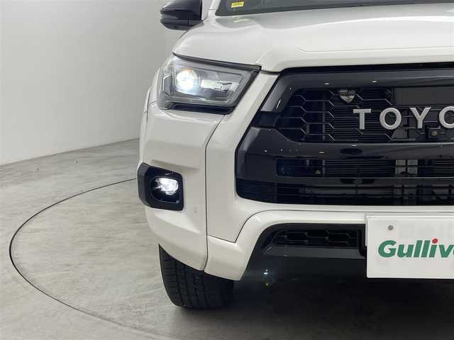 トヨタ ハイラックス Z GRスポーツ 福岡県 2023(令5)年 1万km スーパーホワイトⅡ ワンオーナー　/純正８型ナビ　/全方位カメラ　/純正ベッドライナー　/トノカバー　/ETC　/前後ドライブレコーダー　/レーダークルコン　/コーナーセンサー　/衝突被害軽減ブレーキ　/レーンキープ　/ヒルディセントコントロール　/パドルシフト　/ハーフレザーシート　/パワーシート