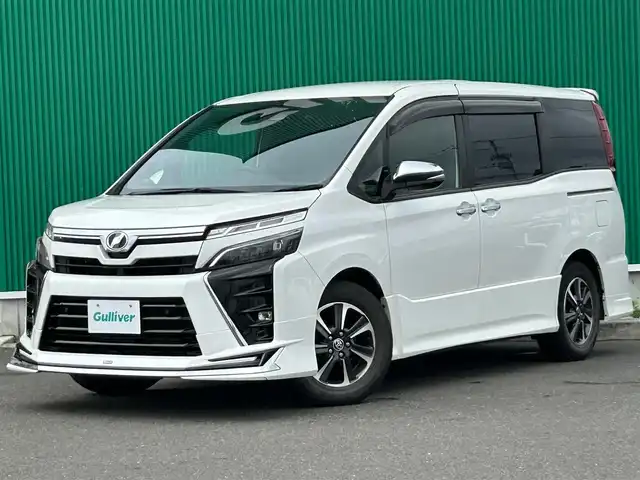 トヨタ ヴォクシー ZS 煌Ⅱ 宮城県 2020(令2)年 6.8万km ホワイトパールクリスタルシャイン モデリスタエアロ（F/S/R）/モデリスタマフラーカッター/セーフティセンス/・プリクラッシュセーフティ/・レーンディパーチャーアラート/・オートマチックハイビーム/先行車発進告知機能/インテリジェントクリアランスソナー/アルパイン12.8インチフリップダウンモニター/アルパイン11インチナビ（EX11NX）/・CD/DVD/・Bluetooth/・フルセグTV/バックカメラ/ビルトインETC/両側パワースライドドア/革調シートカバー/社外シフトノブ/革巻きステアリング/クルーズコントロール/LEDヘッドランプ/フォグランプ/オートライト/スマートキー＆プッシュスタート/電動格納ミラー/純正16インチAW/フロアマット/ドアバイザー/Wエアバッグ