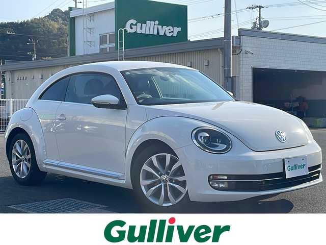 フォルクスワーゲン ザ・ビートル デザイン レザーパッケージ 山口県 2012(平24)年 10万km 白 社外HDDナビ/Bluetooth/フルセグTV/リモコンキー/キセノンライト/黒レザーシート/前席シートヒーター/クルーズコントロール/ETC/純正17インチAW/取扱説明書/スペアキー1個