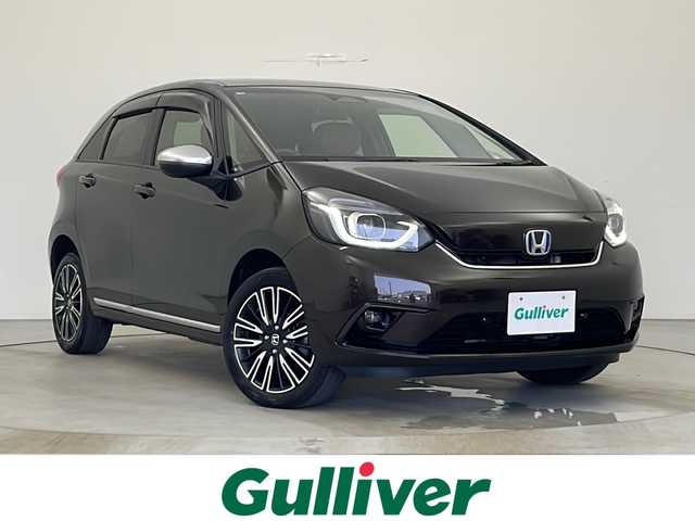 ホンダ フィット e:HEVリュクス 秋田県 2020(令2)年 4.9万km プレミアムグラマラスブロンズP 4WD/純正ナビ/(FM/AM/フルセグTV/Bluetooth/CD/DCD)/バックカメラ/ハーフレザーシート/ホンダセンシング/衝突軽減装置/レーンキープアシスト/コーナーセンサー/クルーズコントロール/横滑り防止装置/アイドリングストップ/オートブレーキホールド/ワイパーデアイサー/ビルトインETC/ドライブレコーダー/ステアリングリモコン/前席シートヒーター/ドアミラーヒーター/ステアリングヒーター/LEDヘッドライト/フォグランプ/オートライト/置くだけ充電/純正アルミホイール/純正フロアマット/プッシュスタート/スマートキー