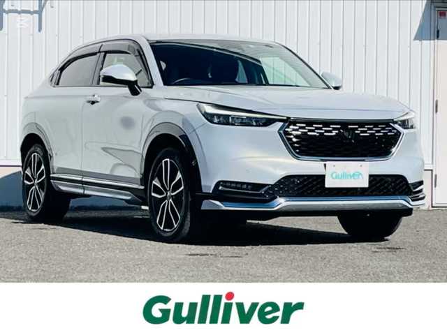 ホンダ ヴェゼル ハイブリッド e:HEV Z 熊本県 2022(令4)年 5.3万km プレミアムサンライトホワイトパール 純正ナビ/・AM/FM/USB/BT/・AppleCarPlay/AndroidAuto/・フルセグTV/バックカメラ/路外逸脱抑制機能/ブラインドスポットインフォメーション/踏み間違い衝突軽減システム/衝突軽減ブレーキ/オートマチックハイビーム/アダプティブクルーズコントロール/前後コーナーセンサー/革巻きステアリング/・ステアリングヒーター/・ステアリングリモコン/・パドルシフト/ハーフレザーシート/・D/N席シートヒーター/オートライト/・LEDライト/・フォグランプ/置くだけ充電/前後ドライブレコーダー/ETC2.0/電動格納ミラー/・ウィンカーミラー/電動サイドブレーキ/・ホールドボタン/ドアバイザー/トノカバー/純正フロアマット/純正アルミホイール/スマートキー/・スペアキー