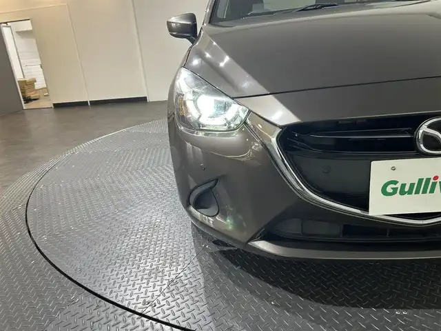 マツダ デミオ 15Sツーリング 愛媛県 2019(令1)年 4.2万km チタニウムフラッシュマイカ 純正メモリナビ/(AM/FM/CD/DVD/Bluetooth/フルセグ)/全周囲/バックカメラ/ヘッドアップディスプレイ/衝突被害軽減ブレーキ/ブラインドスポットモニター/レーンキープアシスト/オートマチックハイビーム/オートライト/アイドリングストップ/ウィンカーミラー/プッシュスタート/ETC
