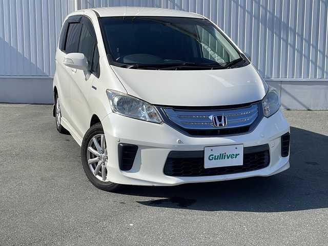 ホンダ フリード ハイブリット ジャストセレクション 三重県 2012(平24)年 13.2万km プレミアムホワイトパール 純正ナビ、フルセグTV/純正CD、DVD再生、Bluetooth/純正フリップダウンモニター/両側パワースライドドア/前後ドライブレコーダー/バックカメラ/クルーズコントロール/コーナーセンサー/社外アルミ15インチ/スマートキー/スペアキー/HIDライト/電動格納ミラー/オートライト