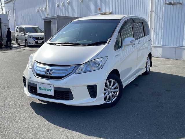 ホンダ フリード ハイブリット ジャストセレクション 三重県 2012(平24)年 13.2万km プレミアムホワイトパール 純正ナビ、フルセグTV/純正CD、DVD再生、Bluetooth/純正フリップダウンモニター/両側パワースライドドア/前後ドライブレコーダー/バックカメラ/クルーズコントロール/コーナーセンサー/社外アルミ15インチ/スマートキー/スペアキー/HIDライト/電動格納ミラー/オートライト