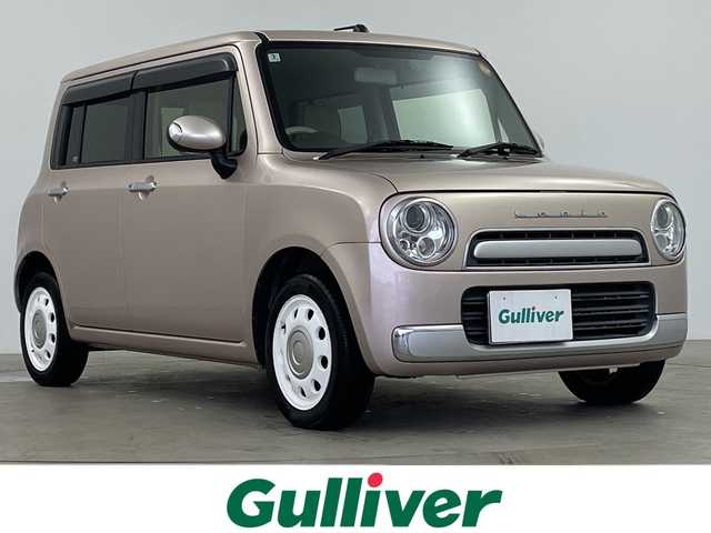 スズキ ラパン ショコラ X 鹿児島県 2014(平26)年 6.5万km シャンパンピンクPM 純正ナビ/(BT/AM/FM/ワンセグTV)/前方ドライブレコーダー/バックカメラ/レザーシート/アイドリングストップ/革巻きステアリング/ウィンカーミラー/ベンチシート/純正フロアマット/オートライト