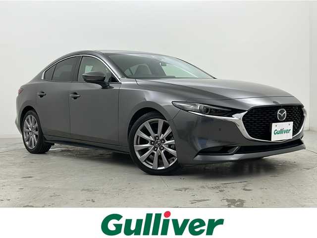 マツダ マツダ３セダン XD Lパッケージ 宮城県 2019(令1)年 6.2万km マシーングレープレミアムM 禁煙車/BOSEサウンド/i-ACTIVSENSE/・アダプティブ・LED・ヘッドライト/・クルージング＆トラフィック・サポート/・ブラインド・スポット・モニタリング/・トラクション・コントロール・システム/・アイ・ストップ/・レーンキープ・アシスト・システム/・スマート・ブレーキ・サポート/ヘッドアップディスプレイ/全周囲カメラ/本革シート/MAZDAコネクトナビ（地図SD無し）/・BT/AM/FM/CD/DVD/USB/HDMI/フルセグTV/ドライブレコーダー/ビルトインETC/電動パーキングブレーキ/オートホールド/前席シートヒーター/運転席パワーシート/シートメモリー/ステアヒーター/革巻きステアリング/ステアリングスイッチ/パドルシフト/プッシュスタート/スマートキー/純正フロアマット/純正18インチアルミホイール/LEDヘッドライト