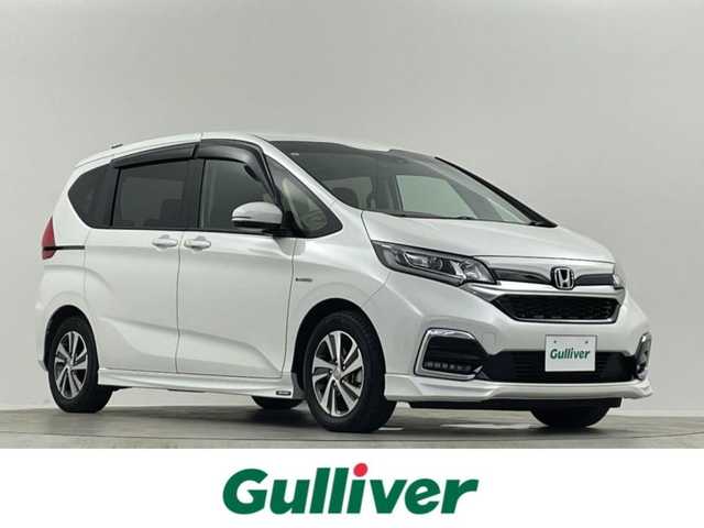 ホンダ フリード ハイブリット G ホンダセンシング 埼玉県 2021(令3)年 2.9万km プラチナホワイトパール 禁煙車　純正９型ナビ　シートヒーター　両側電動パワースライドドア　バックカメラ　　ドライブレコーダー　ＥＴＣ２．０　レーダークルーズコントロール　フルセグＴＶ　寒冷地仕様　ＬＥＤヘッドライト　１００Ｖ電源