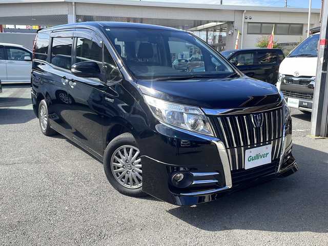 トヨタ エスクァイア ハイブリッド Gi 埼玉県 2015(平27)年 9.7万km ブラック セーフティーセンス/フリップダウンモニター/純正SDナビ/　　Bluetooth/フルセグTV/DVD再生機能/バックカメラ/両側パワースライドドア/クルーズコントロール/LEDオートヘッドライト/レザーシート/運転席、助手席シートヒーター/純正15インチアルミホイール/ワイヤレス充電/アイドリングストップ/ETC