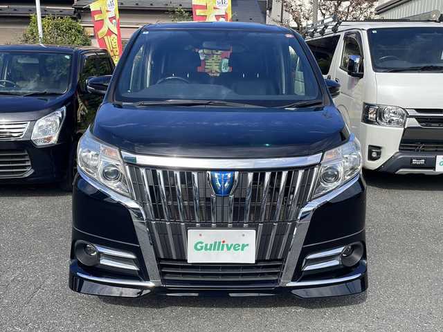 トヨタ エスクァイア ハイブリッド Gi 埼玉県 2015(平27)年 9.7万km ブラック セーフティーセンス/フリップダウンモニター/純正SDナビ/　　Bluetooth/フルセグTV/DVD再生機能/バックカメラ/両側パワースライドドア/クルーズコントロール/LEDオートヘッドライト/レザーシート/運転席、助手席シートヒーター/純正15インチアルミホイール/ワイヤレス充電/アイドリングストップ/ETC