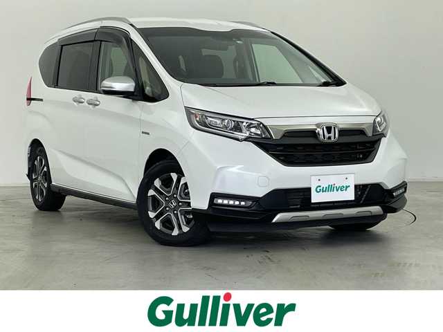 ホンダ フリード ハイブリット クロスター ホンダセンシング 群馬県 2022(令4)年 2.5万km プラチナホワイトパール 7インチナビ/・AM/FM/CD/DVD/USB/Bluetooth/フルセグTV/ホンダセンシング/・衝突軽減ブレーキ（CMBS）/・誤発進/誤後進抑制機能/・路外逸脱抑制機能/・渋滞追従機能付アダプティブクルーズコントロール（ACC）/・車線維持支援システム（LKAS）/・先行車発進お知らせ機能/・標識認識機能/バックカメラ/ハーフレザーシート/LEDライト/両側パワースライドドア/スマートキー/プッシュスタート