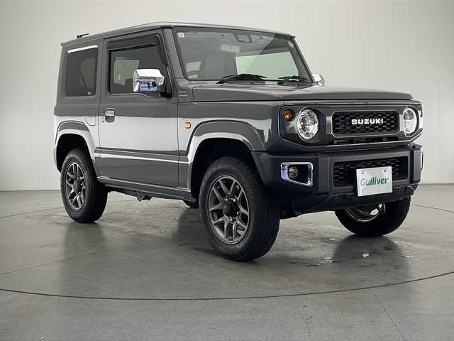 スズキ ジムニー XC 宮崎県 2019(平31)年 2.2万km ミディアムグレー 禁煙車/衝突被害軽減ブレーキ/社外ナビTV/（DPV-7000/CD/DVD/Bluetooth/FMAM/フルセグTV)/社外バックカメラ/社外ETC/純正ドライブレコーダー/純正LEDオートライト/純正LEDフォグ(IPF）/純正16インチアルミ/純正革調シートカバー/純正メッキドアミラーカバー/純正メッキフォグベゼル/純正フロアマット/クルーズコントロール/レーンディパーチャーアラート/ダウンヒルアシストコントロール/前席シートヒーター/ヒーテッドドアミラー/本革巻ハンドル/オートエアコン/スマートキー/プッシュエンジンスタート/新車時保証書/取扱い説明書