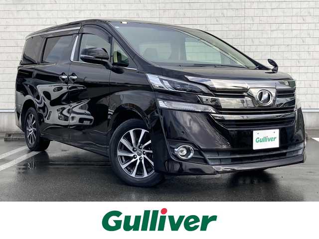 トヨタ ヴェルファイア V 静岡県 2016(平28)年 2.7万km バーニングブラッククリスタルシャインガラスフレーク 純正9インチナビ(NSZT-Y64T)/　AM FM CD DVD Bluetooth SD/フルセグTV/バックモニター/LEDオートヘッドランプ/ハーフレザーシート/運転席パワーシート/クルーズコントロール/前後方クリアランスソナー/両側パワースライドドア/純正17インチアルミホイール/スマートキー2本/ワンオーナー/後席11インチフリップダウンモニター(V11T-R62C)/ビルトインETC