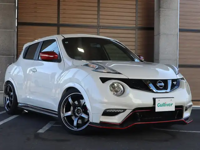 日産 ジューク ニスモ RS 愛知県 2015(平27)年 9.6万km ブリリアントホワイトパール ニスモ専用チューン/純正エアロパーツ/スマートキー×2プッシュスタート/アドバンレーシング18インチアルミホイール/（TC-4）/柿本改マフラー（純正有り）/BLITZ車校調（純正有り）/ニスモ専用シート・フロアマット・スカッフプレート/純正ナビ・フルセグTV・BLUETOOTHオーディオ・DVD・SD（MC314D-W）/バックカメラ/ETC/パドルシフト/純正ディスチャージヘッドライト/純正LEDアクセラリーライナー/オートライト/横滑防止装置/保証書・取扱説明書・ナビ取扱説明書・スペアキー/車検令和8年6月24日/走行距離95673km