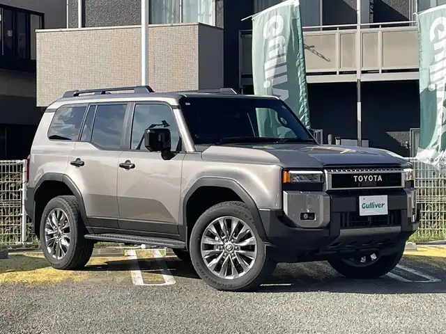 トヨタ ランドクルーザー ２５０ VX 宮城県 2025(令7)年 0.3万km アバンギャルドブロンズメタリック ワンオーナー/純正ナビ/(AM、FM、BT、フルセグTV)/サンルーフ/ルーフレール/スペアキー/純正アルミホイール/３列シート/レーダークルーズコントロール/パノラマビューモニター/バックカメラ/デジタルインナーミラー/ＥＴＣ２．０/フルレザーシート/パワーバックドア/ラバーマット/デフォッガー/オートライト/プリクラッシュセーフティ/パーキングホールド/プッシュスタートボタン/HDMI端子/Cポート/D、N席シートヒーター/クーラー/D席パワーシート/ヒートデアイサー/ステップ