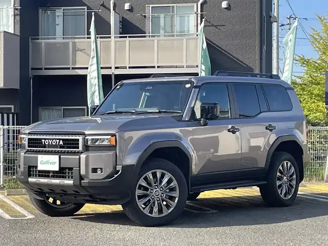 トヨタ ランドクルーザー ２５０ VX 宮城県 2025(令7)年 0.3万km アバンギャルドブロンズメタリック ワンオーナー/純正ナビ/(AM、FM、BT、フルセグTV)/サンルーフ/ルーフレール/スペアキー/純正アルミホイール/３列シート/レーダークルーズコントロール/パノラマビューモニター/バックカメラ/デジタルインナーミラー/ＥＴＣ２．０/フルレザーシート/パワーバックドア/ラバーマット/デフォッガー/オートライト/プリクラッシュセーフティ/パーキングホールド/プッシュスタートボタン/HDMI端子/Cポート/D、N席シートヒーター/クーラー/D席パワーシート/ヒートデアイサー/ステップ
