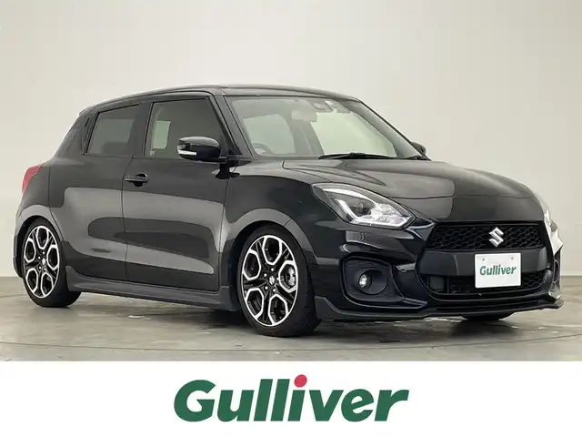 スズキ スイフト スポーツ 滋賀県 2022(令4)年 2.4万km スーパーブラックパール 禁煙車/社外ディスプレイオーディオ/（CD/DVD/USB/Bluetooth）/ビルトインETC/前方ドライブレコーダー/衝突軽減ブレーキ/車線逸脱警報/クリアランスソナー/レーンキープアシスト/革巻きステアリング/追従型クルーズコントロール/ステアリングリモコン/D席シートヒーター/LEDヘッドライト/フォグランプ/オートヘッドライト/BLITZ車高調/純正アルミホイール/純正フロアマット/電動格納ミラー/スペアキー1本