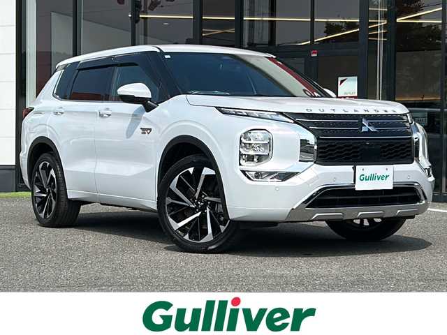 三菱 アウトランダー ＰＨＥＶ P 大阪府 2023(令5)年 1.6万km ホワイトダイヤモンド ワンオーナー/純正メーカーナビ/マイパイロット/ビルトインETC2.0/充電ケーブル/アラウンドビューモニター/ＢＯＳＥプレミアムサウンド/１列目＆２列目シートヒーター/パワーバックドア/クリアランスソナー/プリクラッシュセーフティ/純正20インチAW/AC1500Wコンセント/メモリ機能付きパワーシート/ステアリングスイッチ/BSM/eアシスト/電動パーキングブレーキ/置くだけ充電/取説/保証書/スペアキーｘ１