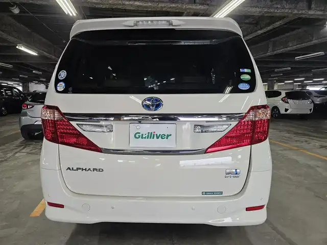 トヨタ アルファードハイブリット G 宮崎県 2013(平25)年 2.8万km ゴールドパールクリスタルシャイン 4WD/ワンオーナー/純正8型ナビ/フルセグTV/両側パワースライドドア/パワーバックドア/バックカメラ/ビルトインETC/ドライブレコーダー/クルーズコントロール/クリアランスソナー/ステアリング連動HIDヘッドランプ/オートライト/デュアルオートエアコン/木目調/革巻きコンビステアリング/ステアリングスイッチ/前席パワーシート/運転席ポジションメモリー/2列目リラックスキャプテンシート/助手席/2列目オットマン/純正16インチアルミホイール/スマートキー/プッシュエンジンスタート/禁煙車