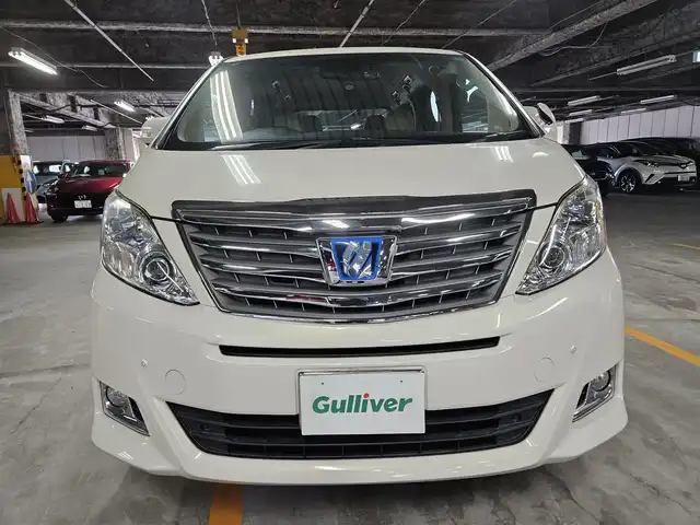 トヨタ アルファードハイブリット G 宮崎県 2013(平25)年 2.8万km ゴールドパールクリスタルシャイン 4WD/ワンオーナー/純正8型ナビ/フルセグTV/両側パワースライドドア/パワーバックドア/バックカメラ/ビルトインETC/ドライブレコーダー/クルーズコントロール/クリアランスソナー/ステアリング連動HIDヘッドランプ/オートライト/デュアルオートエアコン/木目調/革巻きコンビステアリング/ステアリングスイッチ/前席パワーシート/運転席ポジションメモリー/2列目リラックスキャプテンシート/助手席/2列目オットマン/純正16インチアルミホイール/スマートキー/プッシュエンジンスタート/禁煙車