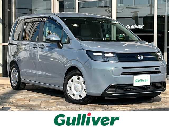 ホンダ フリード AIR 静岡県 2024(令6)年 0.1万km ソニックグレーパール 純正ナビ/・FM/・AM/・TV/・Apple Car Play/・Android Auto/・Bluetooth/・USB/主要装備/・バックカメラ/・ホンダセンシング/・車線逸脱防止/・誤発進抑制/・コーナーセンサー/・追従クルコン/・横滑り防止装置/・ＬＥＤヘッドライト/・サイドカーテンエアバッグ/・純正フロアマット