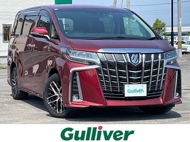 トヨタ アルファード SC 道央・札幌 2020(令2)年 7.3万km ダークレッドマイカメタリック ４WD/JBLプレミアムサウンドシステム/純正ディーラーOPナビ/CD/DVD/BT/フルセグ/純正フリップダウンモニター/トヨタセーフティセンス/プリクラッシュセーフティ/横滑り防止装置/レーダークルーズコントロール/レーンキープアシスト/パーキングアシスト/クリアランスソナー/ブラインドスポットモニター/パーキングサポートブレーキ/リアクロストラフィックアラート/ロードサインアシスト/パノラミックビューモニター/ビルトインETC2.0/ドライブレコーダー/アイドリングストップ/自動防眩ミラー/両側パワースライドドア/パワーバックドア/前席/２列目パワーシート/前席シートヒーター/前席エアシート/D席メモリーシート/N席/２列目オットマン/レザーシート/ステアリングリモコン/ハンドルヒーター/電動パーキング/ブレーキホールド/AC100V/プッシュスタート/スマートキー/LEDヘッドライト/オートライト/オートハイビーム/フォグランプ/電動格納ミラー/ウィンカーミラー/純正フロアマット/ドアバイザー