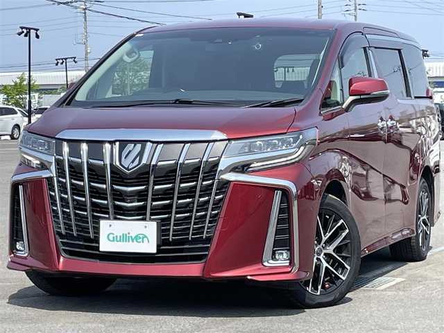 トヨタ アルファード SC 道央・札幌 2020(令2)年 7.3万km ダークレッドマイカメタリック ４WD/JBLプレミアムサウンドシステム/純正ディーラーOPナビ/CD/DVD/BT/フルセグ/純正フリップダウンモニター/トヨタセーフティセンス/プリクラッシュセーフティ/横滑り防止装置/レーダークルーズコントロール/レーンキープアシスト/パーキングアシスト/クリアランスソナー/ブラインドスポットモニター/パーキングサポートブレーキ/リアクロストラフィックアラート/ロードサインアシスト/パノラミックビューモニター/ビルトインETC2.0/ドライブレコーダー/アイドリングストップ/自動防眩ミラー/両側パワースライドドア/パワーバックドア/前席/２列目パワーシート/前席シートヒーター/前席エアシート/D席メモリーシート/N席/２列目オットマン/レザーシート/ステアリングリモコン/ハンドルヒーター/電動パーキング/ブレーキホールド/AC100V/プッシュスタート/スマートキー/LEDヘッドライト/オートライト/オートハイビーム/フォグランプ/電動格納ミラー/ウィンカーミラー/純正フロアマット/ドアバイザー