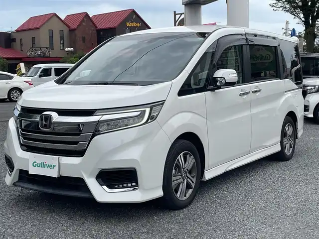 ホンダ ステップワゴン スパーダ eHEV G EXホンダS 大阪府 2021(令3)年 1.4万km プラチナホワイトパール ワンオーナー/ハーフレーザー/前席シートヒーター/純正ＳＤナビ＆フルセグＴＶ/（ＤＶＤ＆ＣＤ＆ＳＤ＆ＢＴ＆ＵＳＢ）/バックカメラ/ビルトインＥＴＣ２．０/前後ドライブレコーダー/衝突軽減ブレーキ/アダプティブクルーズコントロール/先行車発進通知/車線逸脱防止/レーンキープアシスト/標識検知/両側パワースライドドア/オートホールド/純正エアロ/純正１６inアルミホイール/オートライト/ＬＥＤライト/フォグランプ/電動格納ミラー/スマートキー/プッシュスタート/Ｗ＆サイド＆カーテンエアバッグ/横滑り防止装置/ＡＢＳ/ドアバイザー/フロアマット/新車保証書/取扱説明書（車両＆ナビ）/スマートスペアキー有