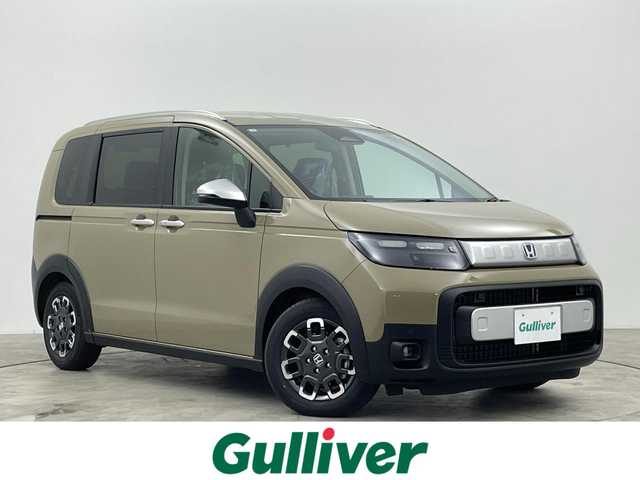 ホンダ フリード ハイブリット e:HEV クロスター 群馬県 2025(令7)年 0.1千km ベージュ 登録済未使用車　純正９インチメモリナビ　両側パワースライドドア　レーダークルーズコントロール　ＢＳＭ　バックカメラ　ステアリングリモコン　シートヒーター　オートライト　プッシュスタート　スマートキー