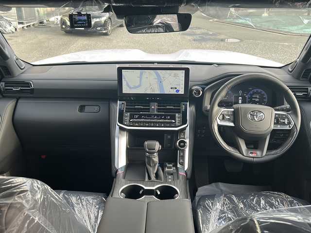トヨタ ランドクルーザー GRスポーツ 愛知県 2025(令7)年 0.1千km プレシャスホワイトパール ワンオーナー/メーカーオプションナビ12.3ディスプレイオーディオ/フルセグTV/BT//JBLプレミアムサウンドシステム/電動サンルーフ/電動デフロック/ブラインドスポットモニター/GRフロアマット/ブラインドスポットモニター/クルーズコントロール/シートヒーター/ベンチレーション/ステアリングヒーター/パワーシート(D・N)/パワーバックドア/デジタルインナーミラー/前後ドライブレコーダー(TZ)/ルーフレール黒/メモリーシート/AC100W/全方位カメラ/LEDヘッドライト/フォグランプ/タイプC充電/ETC2.0/電格ミラー/革巻きステアリング/革シート/スペアキー/純正アルミホイール/ステアリングスイッチ/ミラーウィンカー/イモビライザー/エアバッグ(ダブル＋サイド＋カーテン)/ダウンヒルアシストコントロール/保証書/取扱説明書