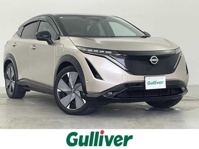 日産 アリア B9 e－4ORCE リミテッド 群馬県 2023(令5)年 1.6万km ゴールド 総電力量91Kwh/パノラミックガラスルーフ/（電動チルト＆スライド、電動格納シェード付、リモート機能付）/ナッパレザーシート/BOSEプレミアムサウンドシステム＆10スピーカー/ヘッドアップディスプレイ/＝＝＝＝＝/EV専用Nissan Connect　ナビゲーションシステム/・12.3インチワイドディスプレイ/・USB/HDMI/Bluetooth/フルセグTV/・Apple Car Play/Android Auto/・Amazon Alexa　搭載　/＝＝＝＝＝/サンルーフ　ナッパレザー　シートベンチレーション　純正メーカーナビ　全周囲モニター　ＢＯＳＥサウンド　プロパイロット　デジタルインナーミラー　駐車支援　ワイヤレス充電　ＨＵＤ　充電ケーブル　禁煙車