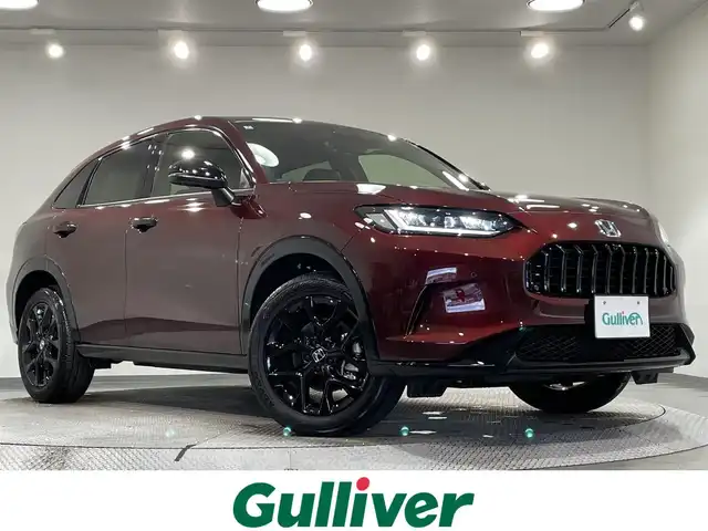 ホンダ ＺＲ－Ｖ ハイブリッド e:HEV Z ブラックスタイル 愛知県 2024(令6)年 0.2万km ワイン カラーコード【R578M】プレミアムクリスタルガーネットM/純正９インチナビ　/(FM/AM/USB/Bluetooth/CarPlay/フルセグTV)/ＢＯＳＥサウンド　/マルチビューカメラ　　/ホンダセンシング/　　-衝突軽減ブレーキ/　　-路外逸脱抑制機能/　　-渋滞追従機能付アダプティブクルーズコントロール/　　-車線維持支援システム/　　-渋滞運転支援機能/　　-先行車発進お知らせ機能/　　-標識認識機能/　　-オートハイビーム/　　-ブラインドスポットインフォメーション/　　-パーキングセンサーシステム/本革シート　/ビルトインＥＴＣ２．０　/全席シートヒーター　/LEDヘッドライト/パワーバックドア　/ワイヤレス充電　/ステアリングヒーター/メモリー機能付電動パワーシート/パドルシフト/オートブレーキホールド機能