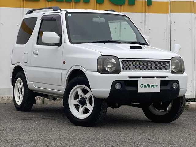スズキ ジムニー XC 埼玉県 2003(平15)年 13.6万km スペリアホワイト ４ＷＤ/ターボ/スズキスポーツマフラー/ヒーテッドドアミラー/社外ＭＯＭＯステアリング/社外１６inアルミホイール/ルーフレール/電動格納ミラー/ＡＢＳ/ドアバイザー/フロアマット/新車保証書/取扱説明書
