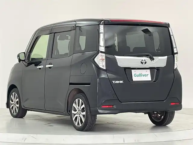 トヨタ タンク カスタムG－T 大阪府 2018(平30)年 1.6万km ブラックマイカメタリック スマートアシスト/・衝突回避支援ブレーキ機能/・衝突警報機能（対車両・対歩行者）、/・車線逸脱警報機能/・誤発進抑制制御機能/・後方誤発進抑制制御機能/・先行車発進お知らせ機能/・クルーズコントロール/純正フロントスポイラー/社外ナビ/　CD/DVD/BT/フルセグTV/バックカメラ/両側パワースライドドア/オートLEDヘッドライト/フォグランプ/前席シートヒーター/純正15インチアルミホイール/後方コーナーセンサー/スマートキー/アイドリングストップ/フロアマット/ドアバイザー