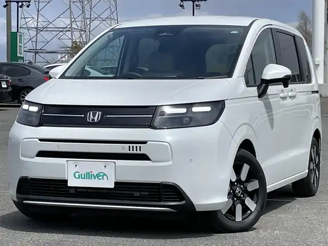 ホンダ フリード AIR EX 道央・札幌 2024(令6)年 0.6万km プラチナホワイトパール 純正ディーラーOPナビ/AM/FM/BT/フルセグ/衝突被害軽減ブレーキ/横滑り防止装置/アダプティブクルーズコントロール/レーンキープアシスト/クリアランスソナー/ブラインドスポットモニター/バックカメラ/ETC/ECONモード/両側パワースライドドア/前席シートヒーター/ハーフレザーシート/革巻きステアリング/ステアリングリモコン/電動パーキング/ブレーキホールド/プッシュスタート/スマートキー/LEDヘッドライト/オートライト/オートハイビーム/電動格納ミラー/ウィンカーミラー/純正フロアマット/スペアキー/レンタカー登録