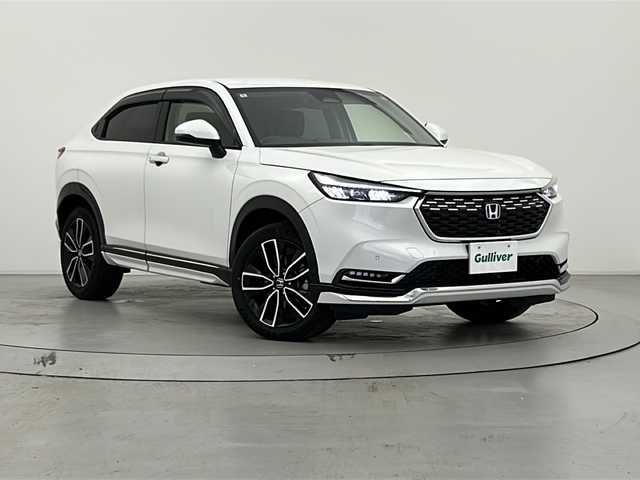 ホンダ ヴェゼル ハイブリッド e:HEV Z 宮城県 2022(令4)年 1.3万km プラチナホワイトパール 純正９インチナビ/（AM/FM/BT/Apple Car Play/Android Auto)/フルセグTV/レーダークルーズコントロール/パワーバックドア/前席シートヒーター/ステアリングヒーター/置くだけ充電/バックカメラ/ETC2.0/BSM/ハーフレザー/パドルシフト/前後コーナーセンサー/ダウンヒルアシストコントロール/LEDヘッドライト/純正18インチアルミホイール/純ドアバイザー