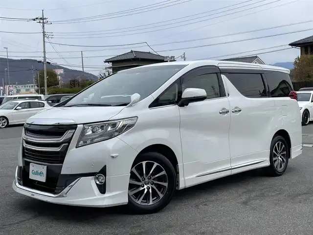 トヨタ アルファード G 山梨県 2016(平28)年 8.1万km ホワイトパールクリスタルシャイン 4WD/モデリスタエアロ/ALPINE製フリップダウンモニター/ALPINE製ナビ/Bluetooth接続/フルセグTV/バックカメラ/サイドカメラ/ハーフレザー調シート/オットマン/電動リアゲート/ETC/両側電動スライドドア/スペアキー１本/取扱説明書/保証書