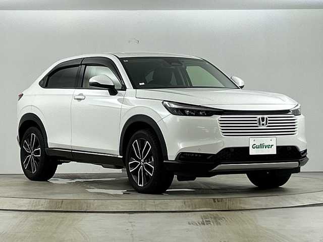 ホンダ ヴェゼル ハイブリッド e:HEV Z 愛知県 2024(令6)年 1.4万km プラチナホワイトパール 禁煙車/ワンオーナー/純正9インチナビ/（AM/FM/Bluetooth/フルセグTV）/バックカメラ/ワイヤレス充電/ホンダセンシング/・衝突軽減ブレーキ/・先行車発信お知らせ機能/・アダプティブクルーズコントロール/・ブラインドスポットモニター/・オートマチックハイビーム/前後コーナーセンサー/ETC2.0/シートヒーター/ハーフレザーシート/パドルシフト/ステアリングヒーター/パワーバックドア/スマートキー/スペアキー有/純正アルミホイール