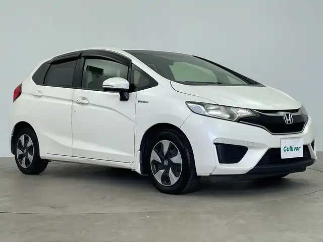 ホンダ フィット ハイブリット Fパッケージ 鹿児島県 2016(平28)年 14.8万km プレミアムホワイトパールⅡ 純正メモリナビ/(BT/CD/DVD/AM/FM/フルセグTV)/バックカメラ/ステアリングスイッチ/ETC/電動格納ミラー/純正フロアマット/純正ドアバイザー/パワーウィンドウ/パワーステアリング/保証書/取扱説明書
