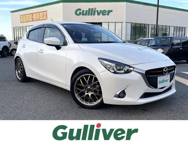 マツダ デミオ XD ツーリング 鳥取県 2015(平27)年 4.6万km スノーフレイクホワイトパールマイカ ディーゼル・ターボ/純正ナビ／フルセグ／ＤＶＤ／ＣＤ／ＢＴ/ＥＴＣ・ドライブレコーダー/衝突軽減ブレーキ/クルーズコントロール/パドルシフト/ＬＥＤヘットライト/フォグライト/ヘットアップディスプレイ/社外サスペンション（減衰調整付き）/社外１７インチアルミホイール/プッシュエンジンスタート/オートライト/フロアマット/ドアバイザー