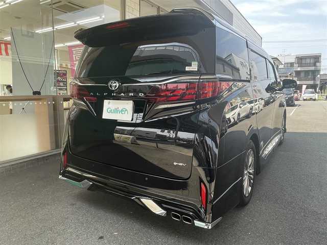 トヨタ アルファードハイブリット Z 愛知県 2024(令6)年 0.9万km ブラック ワンオーナー/モデリスタエアロキット/・フロント／サイド／リアアンダー／ドレスアップマフラー/黒合皮シート/前席2列目シートヒーター＆ベンチレーション/前席パワーシート/2列目エグゼクティブパワーシート/両側パワースライドドア/純正14型ディスプレイオーディオ/・車載ナビ／地デジTV／USB／HDMI/・Apple Car Play／Android Auto/パノラミックビューモニター〈床下透過表示機能〉/純正13.2型有機ELフリップダウンモニター/デジタルインナーミラー/ビルトインETC2.0/ワイヤレス充電/3眼LEDヘッドライト/純正18インチAW/TOYOTA SAFETY SENSE/・プリクラッシュセーフティ/・レーントレーシングアシスト/・レーンディパーチャーアラート/・全車速追従機能付レーダークルーズコントロール/・アダプティブハイビームシステム/・先行車発進告知/・プロアクティブドライビングアシスト/ブラインドスポットモニター/パーキングサポートブレーキ/スマートキー