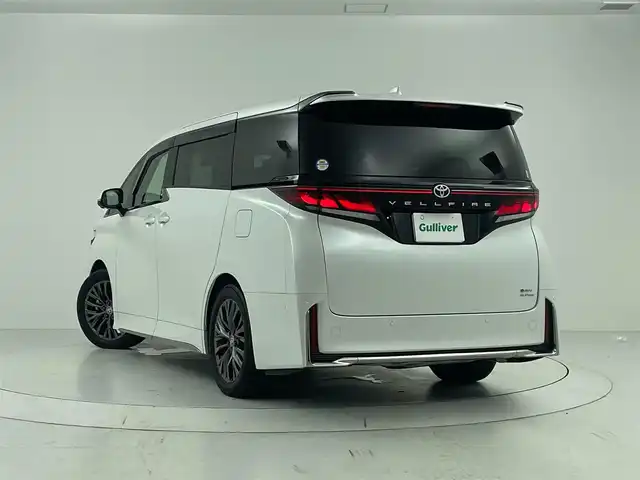トヨタ ヴェルファイア ハイブリット Z プレミア 大分県 2023(令5)年 5万km プラチナホワイトパールマイカ Toyota Safety Sense/・プリクラッシュセーフティ/・レーントレーシングアシスト/・レーンディパーチャーアラート/・レーダークルーズコントロール/・アダプティブハイビームシステム/・オートマチックハイビーム/・ロードサインアシスト/・ドライバー異常時対応システム/・プロアクティブドライビングアシスト/・発進遅れ告知機能/・緊急時操舵支援（アクティブ操舵機能付）/フロントクロストラフィックアラート/・レーンチェンジアシスト/ツインムーンルーフ/フリップダウンモニター/純正メモリナビ/　BT/フルセグTV/・パノラミックビューモニター（床下透過表示機能付）/・両側パワースライドドア/LEDヘッドライト/ハーフレザーシート/パワーシート（1列目・2列目）/シートヒーター（1列目・2列目）/エアーシート（1列目・2列目）/純正19インチアルミホイール/前後コーナーセンサー/スマートキー/ビルトインETC2.0/オットマン/純正フロアマット
