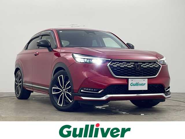 ホンダ ヴェゼル ハイブリッド e:HEV Z 秋田県 2021(令3)年 3.3万km プレミアムクリスタルレッドM 4WD/純正ナビ　/フルセグTV　/全方位カメラ　/ETC2.0/横滑り防止装置 /前後ドライブレコーダー /クルーズコントロール/ステアリングリモコン /プッシュスタート /クリアランスソナー /フロントワイパーデアイサー/ステアリングヒーター/ヒルディセントコントロール/DRIVE　MODE/前席シートヒーター/オートエアコン/パドルシフト/USBポート/革巻きステアリング/ハーフレザーシート/自動パーキングブレーキ/ブレーキホールド/電動リアゲート/コーナーセンサー/プッシュスタート/ワイヤレス充電/フォグライト/サイドバイザー/ウィンカーミラー/純正AW