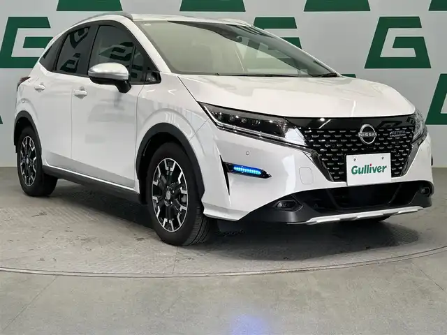 日産 ノート オーテック Xオーバー +アクティブ 鹿児島県 2024(令6)年 1.3万km ピュアホワイトパール 純正9インチナビ（ラジオ、フルセグ、BT、SD）/アラウンドビューモニター/前方ドライブレコーダー/インテリジェントルームミラー/ステアリングリモコン/オートハイビーム/・オートライト/・LEDヘッドライト/・フォグランプ/エマージェンシーブレーキ/速度標識機能/前後コーナーセンサー/ふらつき警報/ブラインドスポットモニター/レーンキープアシスト/純正フロアマット/プッシュスタート/スマートキー/・スペアキー